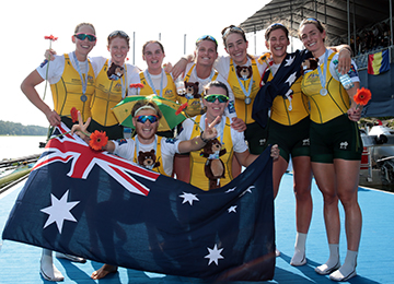 Women's eight celebrate their medal